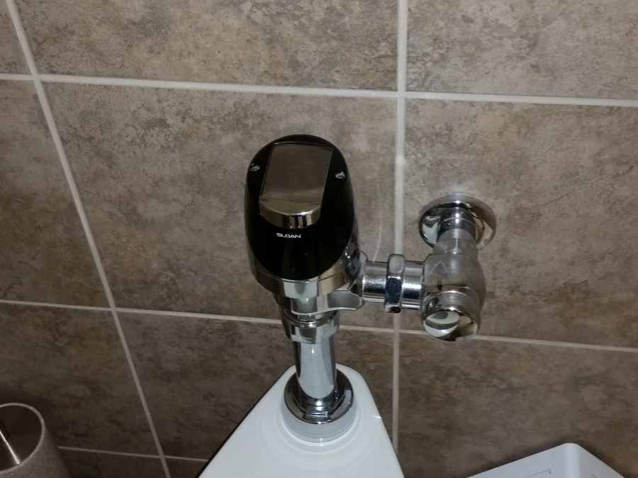 Commercial restroom fixtures and hands-free flushometer