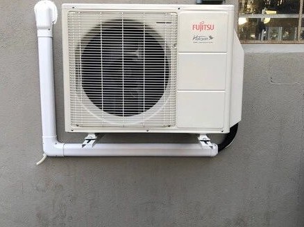 Ductless mini split condenser mounted on a home exterior